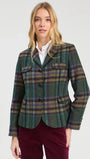 Woman wearing a green plaid wool blazer and white shirt with burgundy trousers.