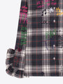 Black and white plaid women's designer blouse with colorful graffiti print and ruffle cuff.